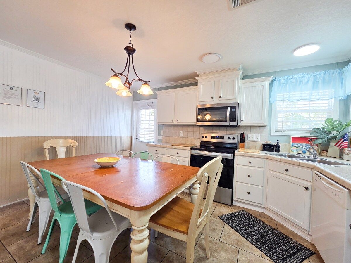 Kitchen with seating for 6 and all necessary items to cook a full meal with Stove, Microwave, Refrigerator, Dishwasher, Coffee Maker, Blender, Toaster, crock pot, etc.