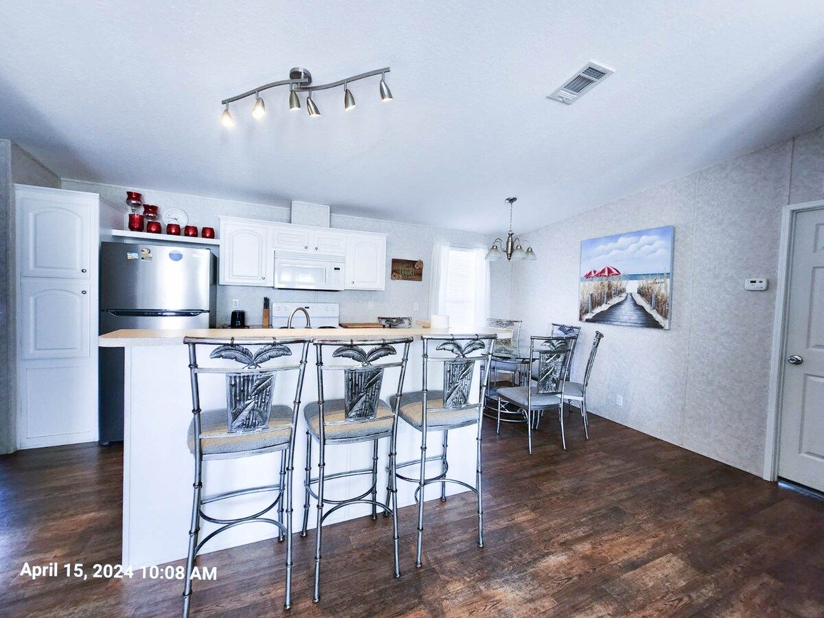 Full Kitchen with microwave, with electric range and cooktop, dishwasher, drip coffee pot, and sink at bar.