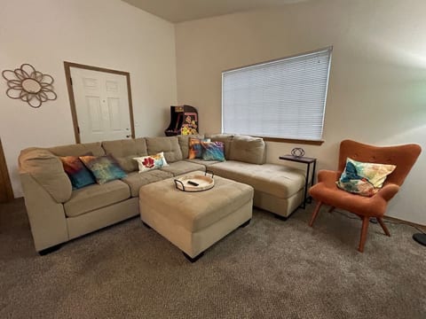 Living room, plush couch with chaise lounge and Ms. Pac Man