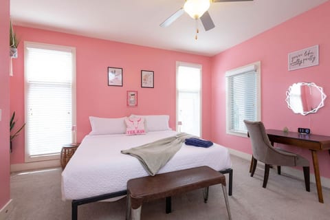 A dreamy retreat with blush-pink walls, a plush king bed, and stylish artwork. This room is perfect for the bride-to-be or trip host who wants a little extra luxury.