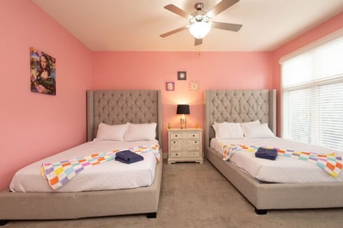 Two elegant tufted queen beds make this room ideal for sharing. Bright, girly, and spacious, it’s perfect for late-night chats and early-morning glam sessions.