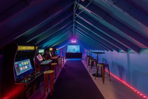 Retro arcade room packed with classic games and vibrant neon vibes. 🕹️⚡
