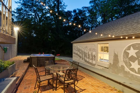 Unwind under the string lights in our private hot tub and outdoor dining area.