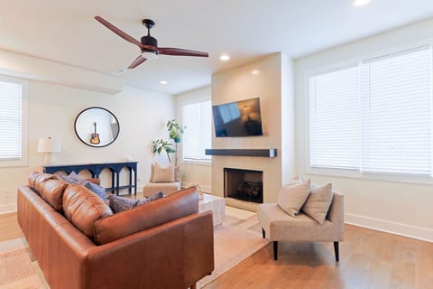 Cozy living room equipped with a modern fireplace and a wall-mounted smart TV.