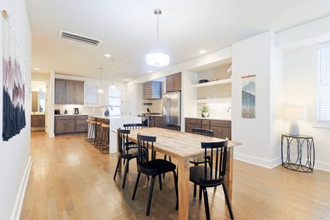 Bright, open layout linking the dining area, kitchen island, and main living space.