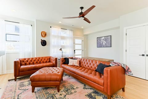 Chic living room featuring elegant brown tufted leather sofas.