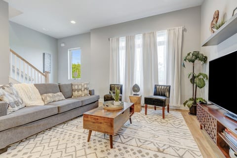 Bright, open living room featuring a massive sectional sofa and modern accents. 🛋️