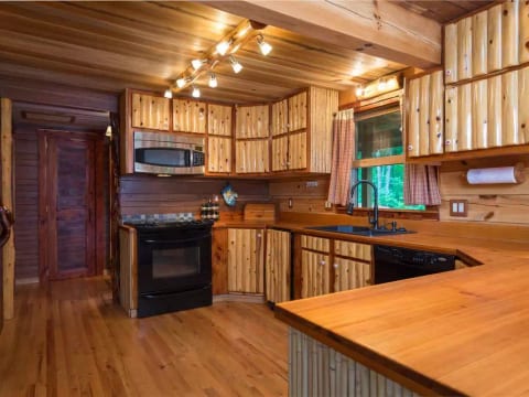 Fully stocked kitchen includes microwave, toaster oven, dishwasher, and standard amenities.