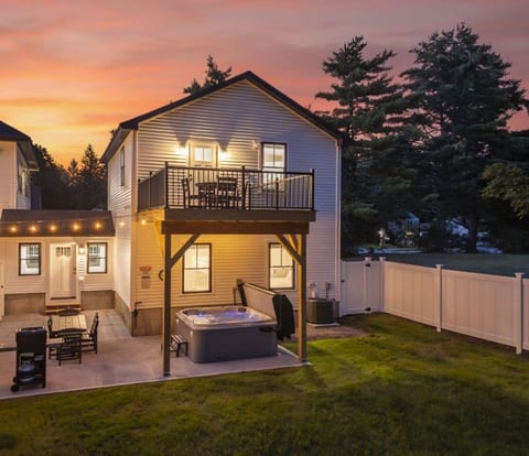 Carriage House: Irrigated Fenced-In Backyard complete with hot tub, grill, large patio with dining table, bistro lights, and 2nd level deck