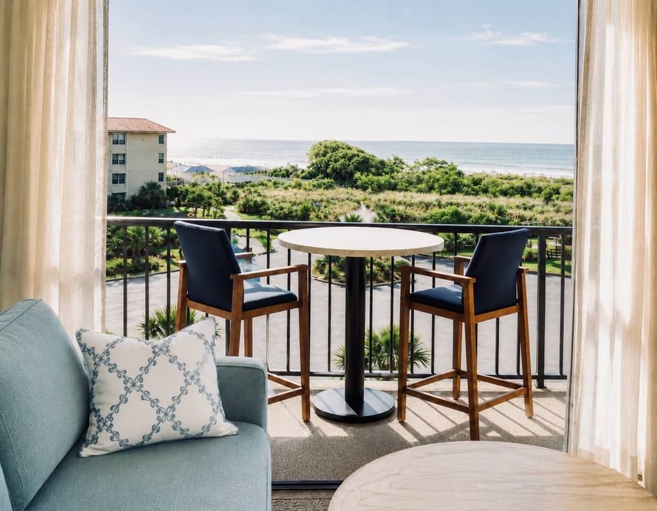 Top-floor oceanview balcony with views of the Atlantic, fountain pond, and beach boardwalk. The perfect spot for sunrise coffee, evening cocktails, and salty ocean breezes.
