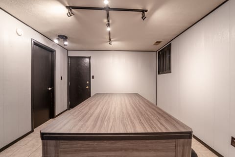 Modern gathering space with large table and bright track lighting