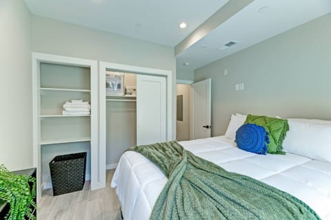 Tranquil Retreat: Rest easy in this serene bedroom, featuring a plush bed with cozy linens, ample closet space, and soft, calming decor—your perfect haven after a day of exploring the city.