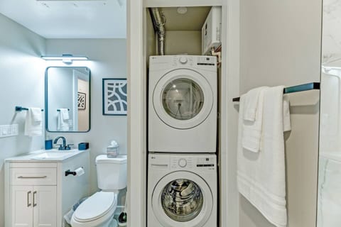 Convenience at Your Fingertips: Enjoy the comfort of in-unit laundry with this stacked washer and dryer, thoughtfully tucked away in the sleek bathroom—making extended stays even more convenient!
