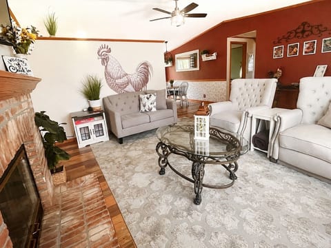 Love seat and two reclining chairs to kick back and watch a movie on the smart tv after a long day of playing on the lake.
