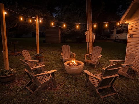 Fire pit just a few steps out the back door with seating for 6. Starter wood is provided. Picnic table also out back for outdoor meals on beautiful days.  Charcoal grill is close by as well.
