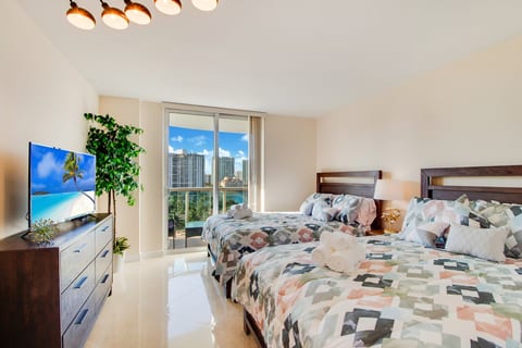 2 bedrooms with a TV and a view