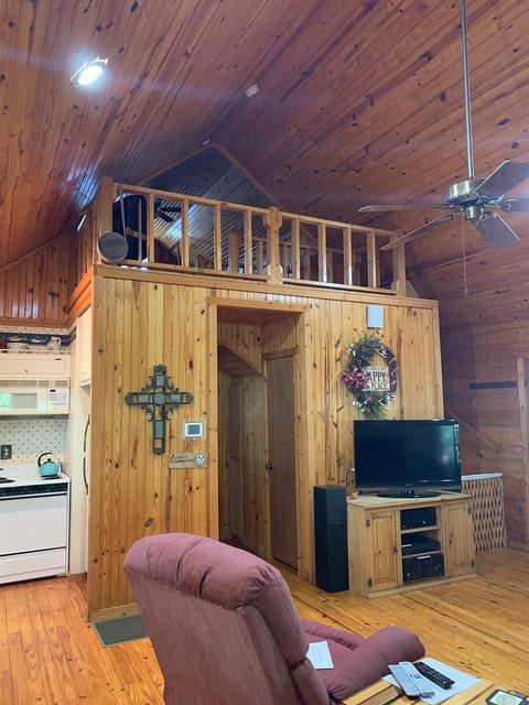 View of upstairs room. Tv in living room has 68 channels and a preloaded dvd player for your viewing (list provided). Baby gate to keep pets small children from upstairs.