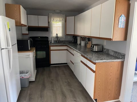 fully stocked kitchen with microwave, dishwasher, keurig coffeemaker, toaster, blender, etc.