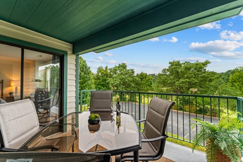 The private covered balcony seats four and opens from both the living room and primary bedroom.