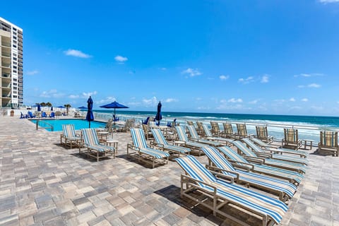 Very Large Pool Deck with Tables, Chairs, Umbrellas, Loungers
