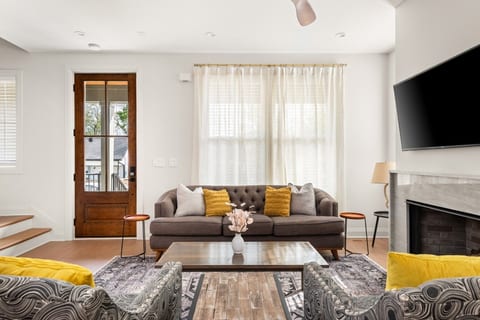 Cozy up in the main living room, featuring a comfortable sofa and rustic wooden coffee table.