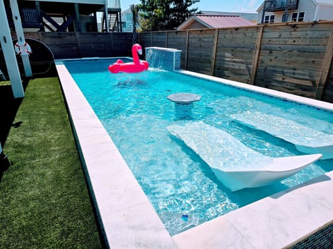 Sun Shelf with Twin Ledge Loungers, Plus In-Pool Cocktail Table. *flamingo not included