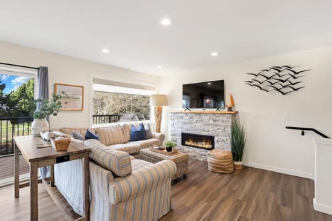 Large living room with a cozy couch and fireplace.
