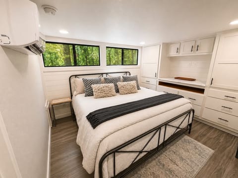 Main bedroom with one king bed. Has a private entrance to the attached full bathroom and a personal AC unit for a custom room temperature.