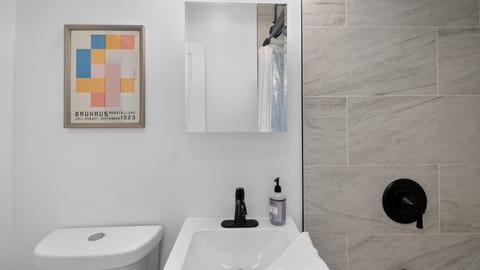 Modern bathroom with sleek black fixtures and stylish tiled shower