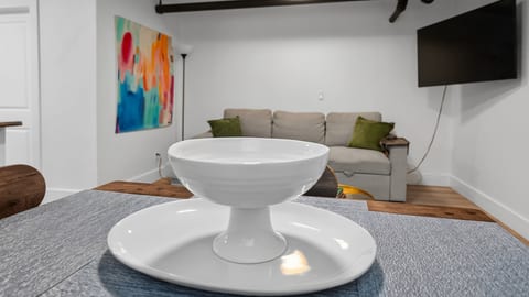 Cozy modern lounge with sofa, TV, and colorful art accents