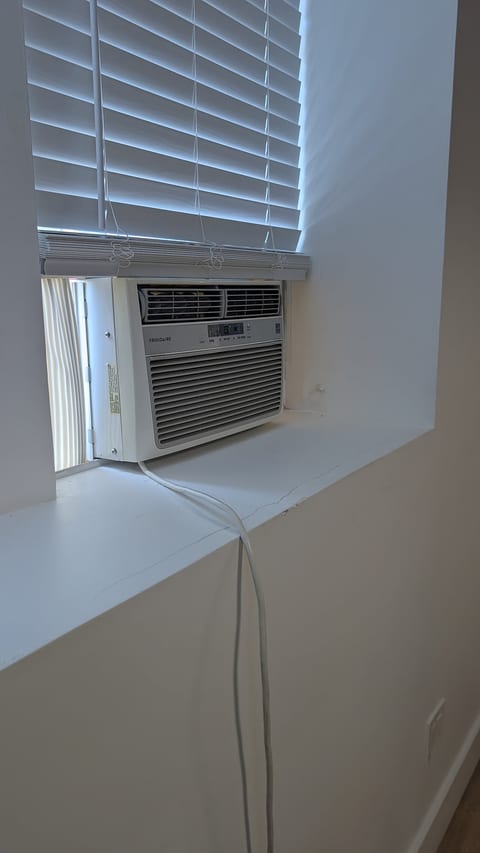 Window AC and privacy blinds for a cool, comfortable stay