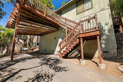 Parking is available at the top of the driveway with a staircase up to the front door.