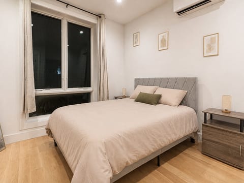 Modern bedroom with queen‑size bed, boho décor and soft lighting ensures restful nights.