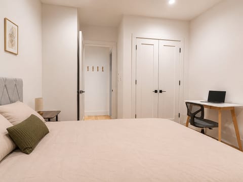 Bedroom features a queen bed and dedicated desk space—ideal for work‑from‑home travelers.