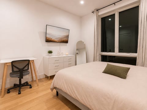 Bedroom features a queen bed and dedicated desk space—ideal for work‑from‑home travelers.