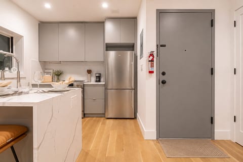 Stainless‑steel appliances, cookware and boho accents make cooking a pleasure.
