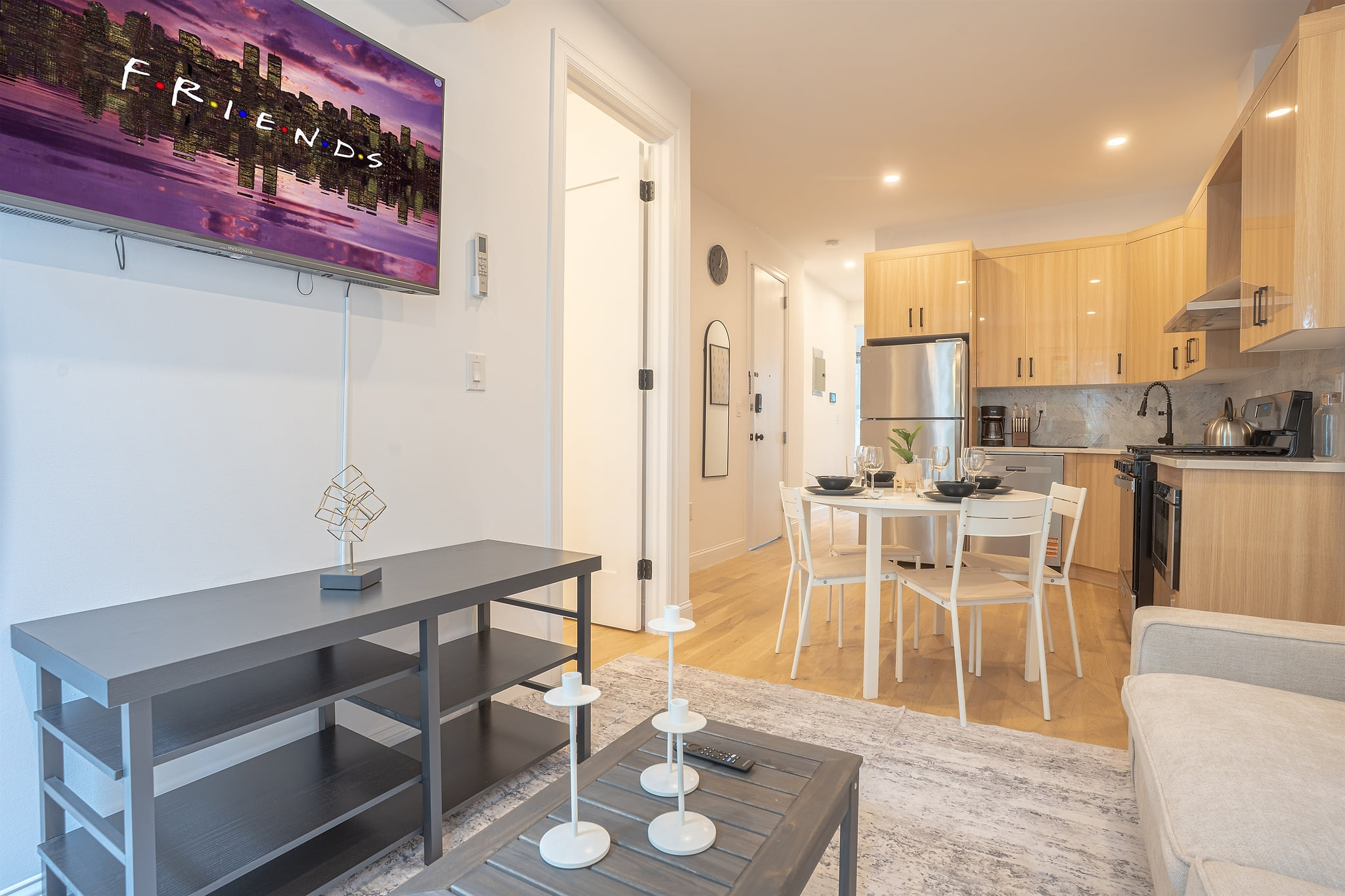 Stylish open-plan unit with kitchen, TV, and cozy dining area