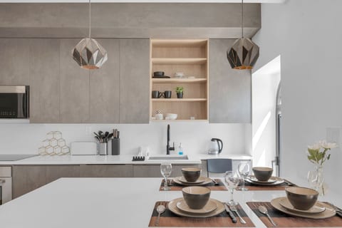 Contemporary kitchen with full-size appliances and a dining table set for guests — cook and gather with ease.