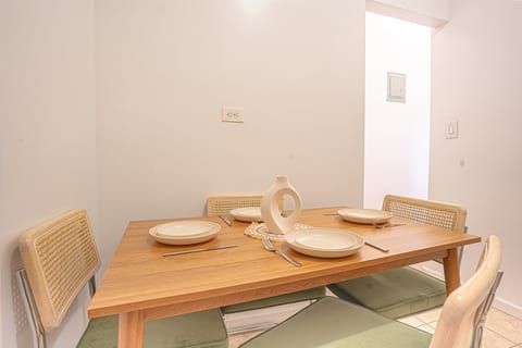 Dedicated dining area seating four — gather for meals together after a day exploring the Upper East Side.