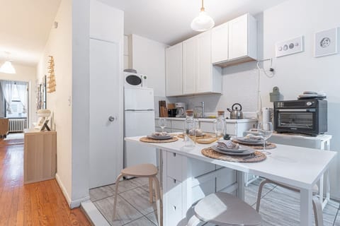 Spacious open-plan living area with hardwood floors and modern décor — perfect for unwinding after a day in Midtown Manhattan.