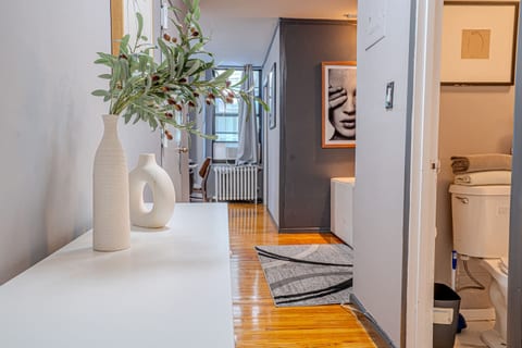 Living area with hardwood floors and modern décor — perfect for relaxing after a day in the city.