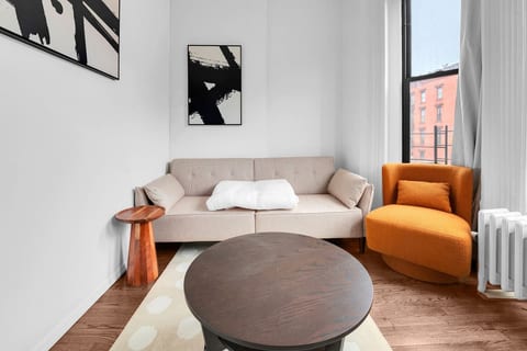 Bright, welcoming living room with plush seating and large windows — your stylish home base in family-friendly Prime Park Slope, Brooklyn.