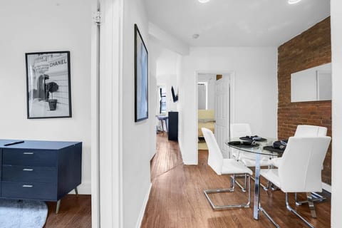 Open hallway flowing into the dining area with brick-accent charm — a warm, contemporary 3BR layout perfect for families and groups.