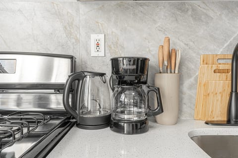 Well-equipped kitchen with stove, kettle, coffee maker, and knife set — cook your favorites any night of your stay.