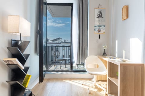 Cozy reading nook by the window — the perfect spot to unwind or catch up on emails in natural light.