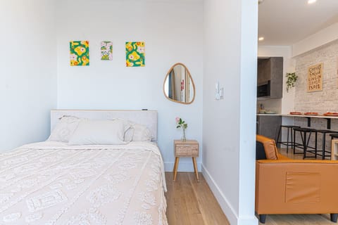 Restful bedroom with a plush bed and crisp linens — your calm Brooklyn retreat after a day in the city.