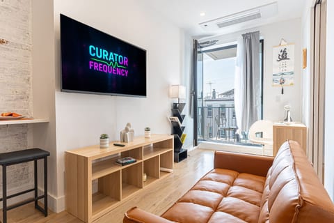 Sink into the sofa in this fully renovated Brooklyn living room — smart TV and bright, modern comfort just minutes from the train.