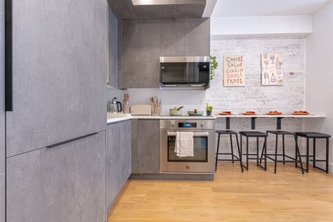 Modern full kitchen with a breakfast bar and full-size appliances — easy to cook and gather between adventures.