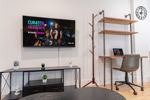 Smart TV viewing area with cozy seating in bright Scandinavian Bushwick 1BD apartment