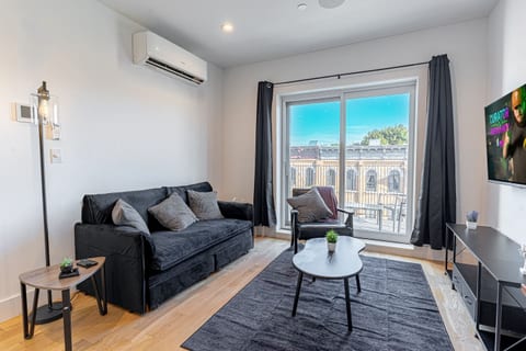 Comfortable sofa in bright living room, ideal for relaxing after exploring Brooklyn and Manhattan